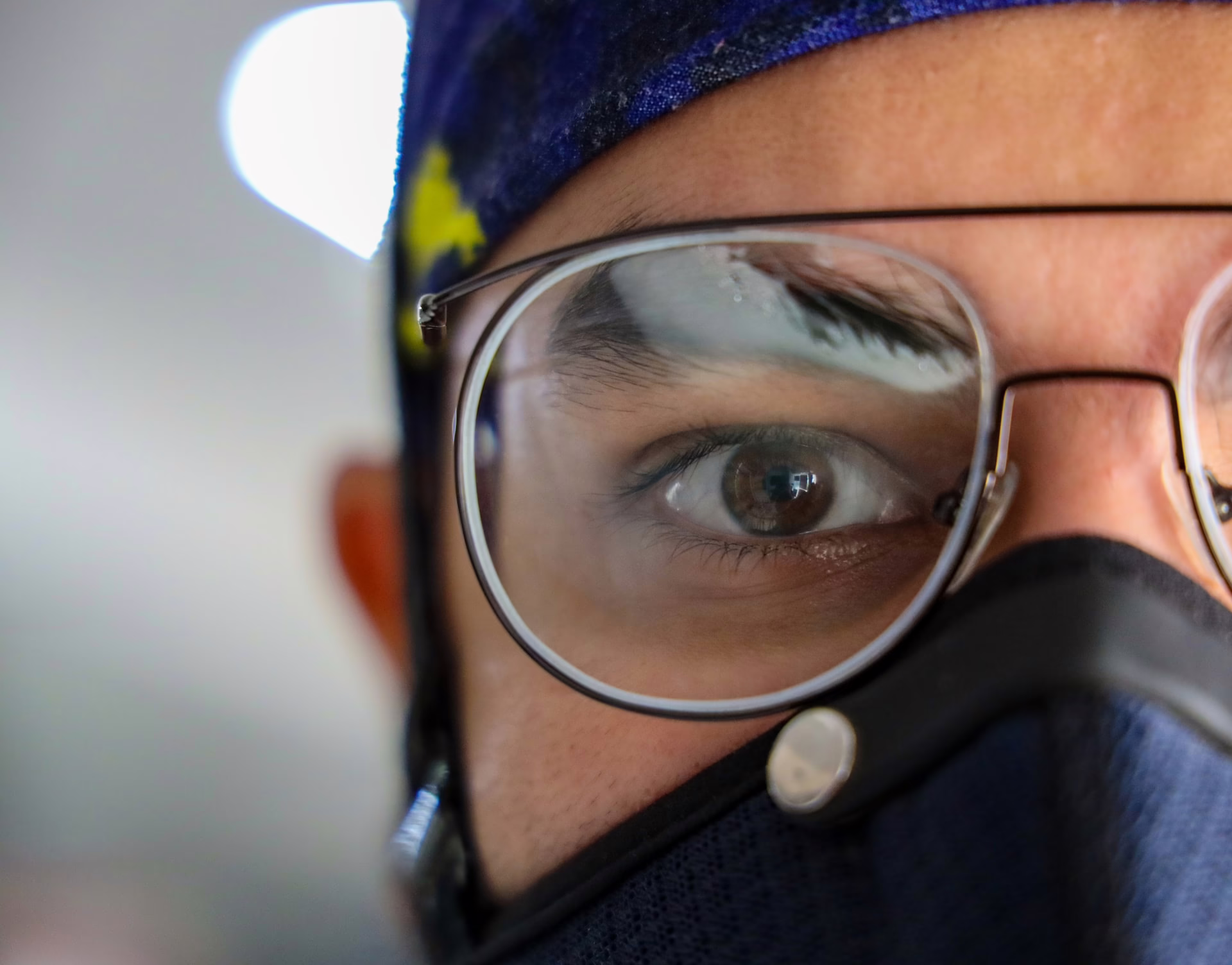 A doctor wearing glasses and a facemask