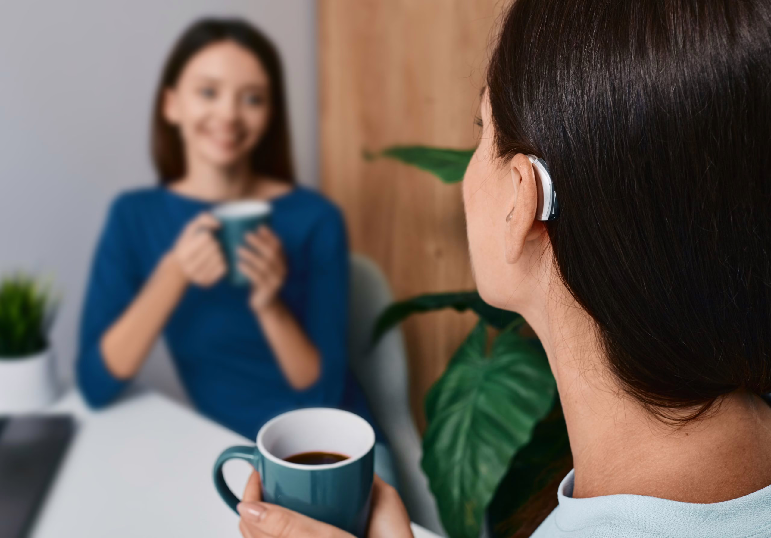two women speaking the hearing specialist